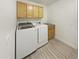 Bright laundry room with washer, dryer and upper cabinets at 13033 W Avalon Dr, Avondale, AZ 85392