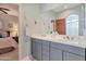 Double vanity bathroom with gray cabinets and a large mirror at 13600 N Fountain Hills Blvd # 604, Fountain Hills, AZ 85268