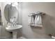 Simple bathroom with pedestal sink, oval mirror and neutral colors at 13600 N Fountain Hills Blvd # 604, Fountain Hills, AZ 85268
