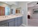 Double vanity bathroom with gray cabinets and a large mirror at 13600 N Fountain Hills Blvd # 604, Fountain Hills, AZ 85268