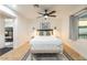 Main bedroom with plush bedding and access to another room at 1720 W Sunnyslope Ln, Phoenix, AZ 85021
