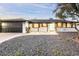 Updated mid-century modern home with dark gray garage door and light-colored exterior at 1720 W Sunnyslope Ln, Phoenix, AZ 85021
