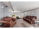 Sunroom with brown leather furniture, creating a relaxing space at 18003 N 134Th Ave, Sun City West, AZ 85375