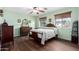 Bedroom with antique wooden bed and light green walls at 18609 W Onyx Ave, Waddell, AZ 85355