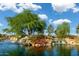 Serene community lake with waterfalls and landscaping at 20571 N Lemon Drop Dr, Maricopa, AZ 85138