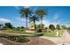 Community entrance with monument sign and palm trees at 20571 N Lemon Drop Dr, Maricopa, AZ 85138