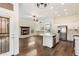 Open concept kitchen with hardwood floors, island, and fireplace at 23113 N 89Th Pl, Scottsdale, AZ 85255