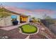 Relaxing backyard with putting green and grill at 2317 N Beverly Pl, Buckeye, AZ 85396