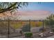 View of backyard beyond a fence, featuring desert landscape at 2317 N Beverly Pl, Buckeye, AZ 85396