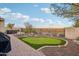 Landscaped backyard featuring a putting green, hot tub, and expansive views at 2317 N Beverly Pl, Buckeye, AZ 85396