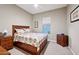 Cozy bedroom with a queen-size bed and wood furniture at 2317 N Beverly Pl, Buckeye, AZ 85396