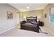 Spacious bedroom with a dark-wood bed frame at 2317 N Beverly Pl, Buckeye, AZ 85396