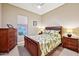 Bright bedroom with a full-size bed and wood furniture at 2317 N Beverly Pl, Buckeye, AZ 85396