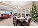 Formal dining room with a view to the living room and a decorated tree at 2317 N Beverly Pl, Buckeye, AZ 85396