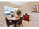 Bright dining room with a charming wooden table and four leather chairs at 2317 N Beverly Pl, Buckeye, AZ 85396
