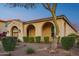 Elegant home with arched entryway and manicured landscaping at 2317 N Beverly Pl, Buckeye, AZ 85396