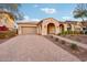 Single-story home with arched entryway and landscaped yard at 2317 N Beverly Pl, Buckeye, AZ 85396