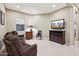 Gathering room with sectional sofa, large TV, and wood cabinet at 2317 N Beverly Pl, Buckeye, AZ 85396