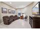 Gathering room featuring a curved sectional sofa and a large TV at 2317 N Beverly Pl, Buckeye, AZ 85396
