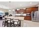 Island kitchen with stainless steel appliances and breakfast bar seating at 2317 N Beverly Pl, Buckeye, AZ 85396