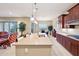 Open kitchen with large island, stainless steel appliances, and breakfast bar at 2317 N Beverly Pl, Buckeye, AZ 85396