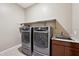 Laundry room with washer, dryer, and utility sink at 2317 N Beverly Pl, Buckeye, AZ 85396