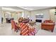 Open living room featuring leather sofas and a view to the dining area at 2317 N Beverly Pl, Buckeye, AZ 85396