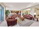 Open concept living room with kitchen view and leather furniture at 2317 N Beverly Pl, Buckeye, AZ 85396