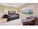 Spacious main bedroom with a large bed, window seating, and ceiling fan at 2317 N Beverly Pl, Buckeye, AZ 85396