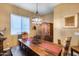 Rustic dining room with wood table, bench, and chandelier at 24280 N 164Th Dr, Surprise, AZ 85387