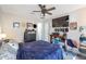 Bright bedroom with a large TV, ceiling fan, and ample storage at 307 E Impala Ct, Casa Grande, AZ 85122