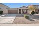 Inviting curb appeal featuring a two-car garage and well-manicured front yard at 307 E Impala Ct, Casa Grande, AZ 85122