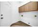 Bright laundry room with built-in cabinets and vinyl flooring at 3531 N 108Th Ave, Avondale, AZ 85392