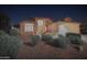 Night view of single-story home with landscaping and two-car garage at 370 W Gail Dr, Gilbert, AZ 85233