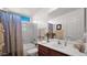 Bright bathroom with shower-tub combo, single sink vanity and decorative mirror at 4686 E Mia Ct, Gilbert, AZ 85298