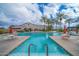 Resort-style swimming pool with lounge chairs and palm trees at 4686 E Mia Ct, Gilbert, AZ 85298