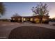 Brick home with landscaped yard, curved driveway, and outdoor lighting at 509 E Adamanda Ct, Phoenix, AZ 85086