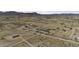Expansive desert landscape showing multiple dwellings, graded roads, and panoramic mountain views at 6326 N Deer Trl, Maricopa, AZ 85139