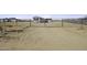 Wide angle shot of the front gate and driveway with tire tracks in the sand at 6326 N Deer Trl, Maricopa, AZ 85139