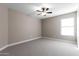 Bright bedroom with ceiling fan and carpet at 6381 W Kristal Way, Glendale, AZ 85308