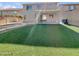 Backyard oasis with a putting green and covered patio at 6520 W Eagle Talon Trl, Phoenix, AZ 85083