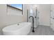 Relaxing bathroom with a soaking tub, walk-in shower, and patterned floor tiles at 685 E Greenback Dr, San Tan Valley, AZ 85140