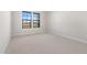 Simple bedroom with neutral carpeting and two windows at 685 E Greenback Dr, San Tan Valley, AZ 85140