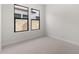 Spacious bedroom with neutral carpeting and two windows at 685 E Greenback Dr, San Tan Valley, AZ 85140