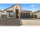 Modern house with a brown garage door and stone accents at 685 E Greenback Dr, San Tan Valley, AZ 85140