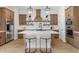 Modern kitchen with an island, wood cabinets, and stainless steel appliances at 685 E Greenback Dr, San Tan Valley, AZ 85140