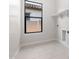 Bright laundry room with built-in shelving and tile flooring at 685 E Greenback Dr, San Tan Valley, AZ 85140