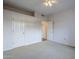 Bedroom with ceiling fan, double door closet and carpet flooring at 6920 E 4Th St # 105, Scottsdale, AZ 85251