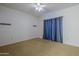 Bright bedroom with ceiling fan and blue curtains at 6920 E 4Th St # 105, Scottsdale, AZ 85251