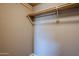 Simple closet with wood shelving and hanging rod at 6920 E 4Th St # 105, Scottsdale, AZ 85251